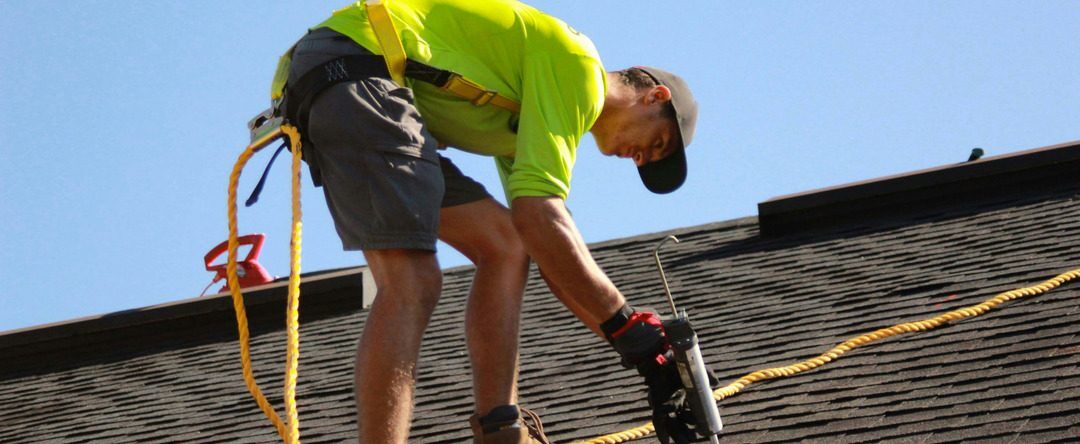 Roofing and waterproofing contractor working on a residential roof in New York City